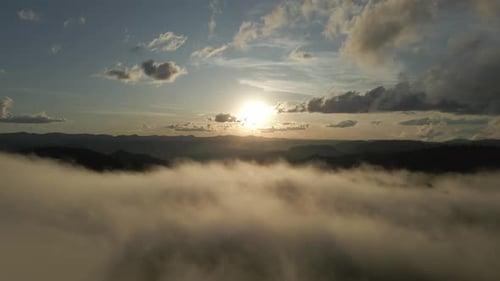Sea Of Clouds With Sunset Light In The Background. Aerial Shot