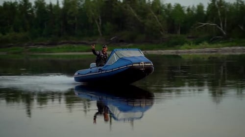 Fisherman Sails His Blue Boat Down the River in Slow Motion and Shows a Goat