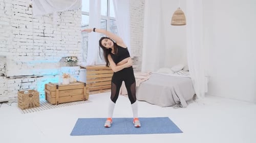 Woman Doing Stretching Exercises at Home