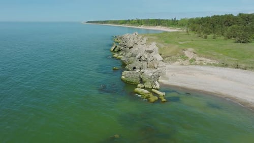 Beautiful aerial establishing view of Karosta (Liepaja) concrete coast fortification ruins, calm Bal