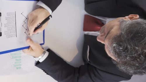 Businessman Amends Graph Data in Office Environment