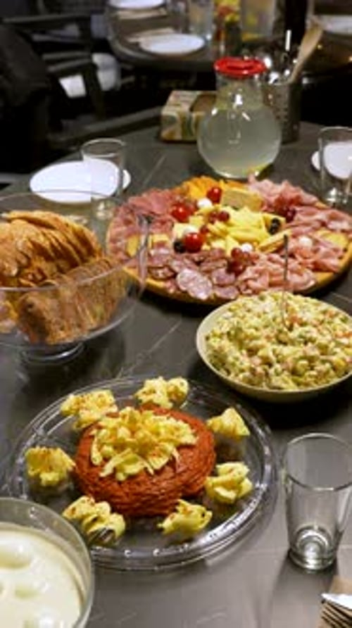 Abundant Appetizer Spread with Charcuterie and Salads on a Dinner Table