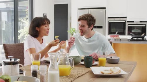 Couple Sharing Breakfast and Conversation in Modern Kitchen
