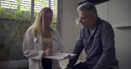 Doctor Consults Patient in Bright Modern Medical Clinic