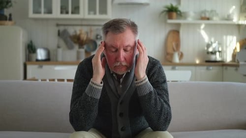 Man Massaging Head Suffering from Headache Pain