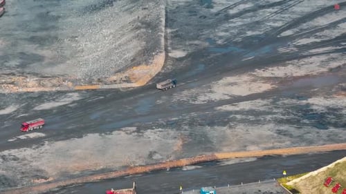 Heavy Coal Mining Trucks Operating at a Large Open Pit Mine