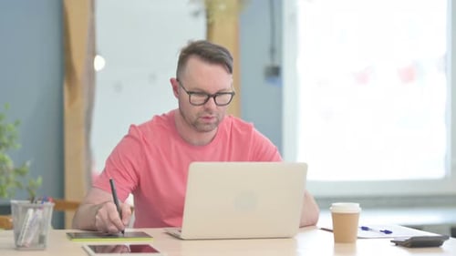 Designer Working at Desk with Graphics Tablet