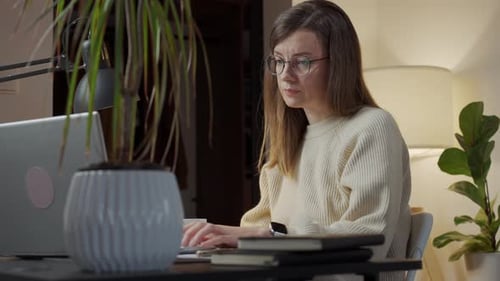 Woman with Neck Pain Working at Desk in Home Office