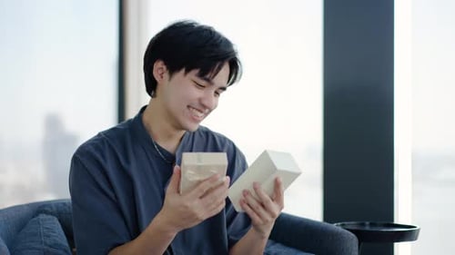 Man Smiles Opening Birthday Gift