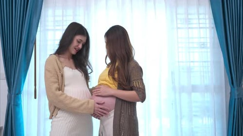 Two Pregnant Friends Touch Each Other's Bellies