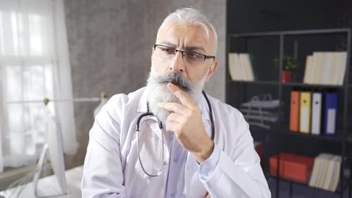 The thoughtful senior doctor has many problems on his mind.