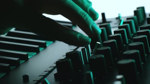 Hand Adjusting Levels on a Soundboard