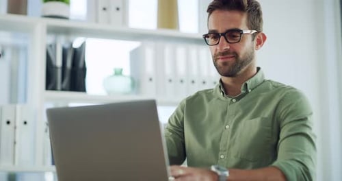 Man Working on Laptop in Bright Modern Office