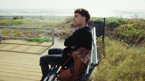 Man On The Bench Near The Sea Relaxing And Enjoying The Nature