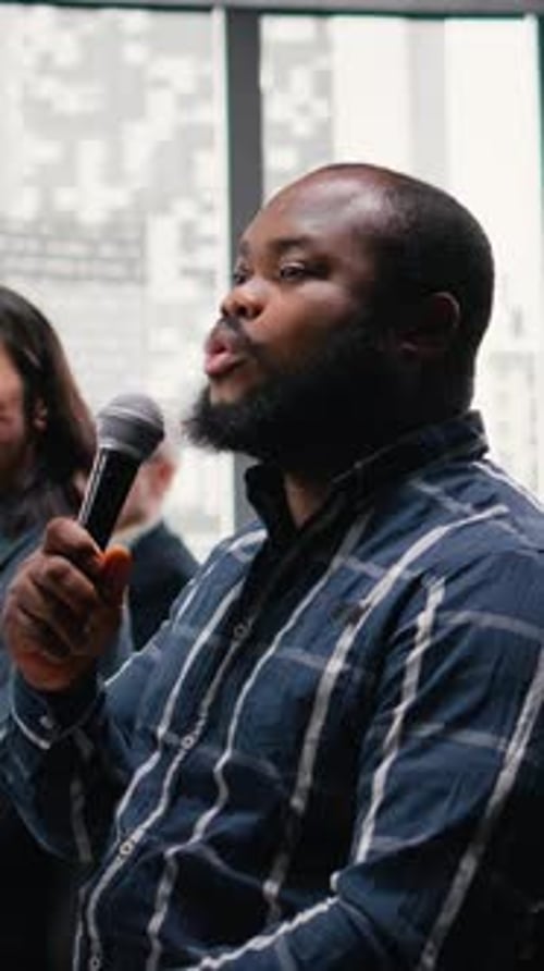 Man Speaks at Corporate Conference with Microphone