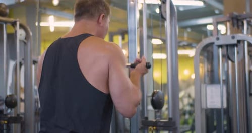 Gym Workout Bicep Exercise Middle Aged Caucasian Man Trains His Bicep Muscles in the Gym
