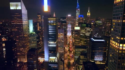 Light broad street among the sparkling skyscrapers. Fantastic New York panorama at night time.