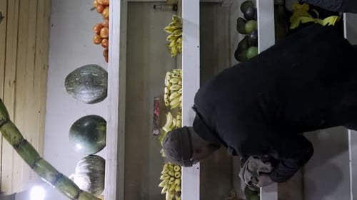 Shop Owners Replenishing Their Shelves with a Fresh Supply of Fruits in Kenya, East Africa - Vertica