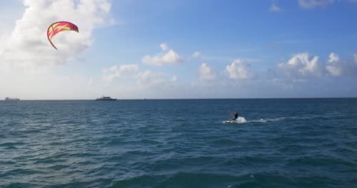 Man Kite Surfing, Wind Surfing, in Tropical Ocean Acrobatic