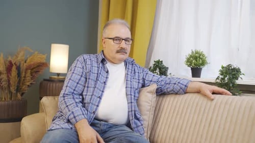 Man looking at camera with dull expression.