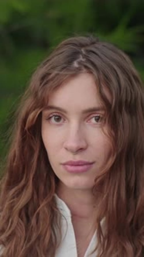 Attractive Woman with Light Brown Hair Stares at Camera