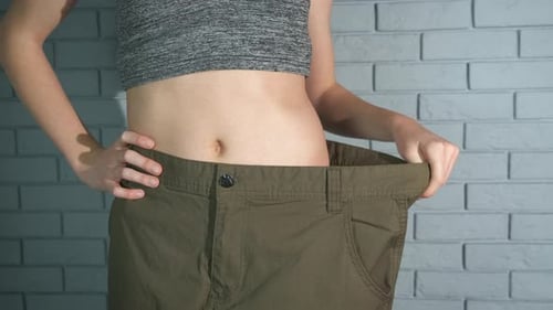Thin athlete girl in jeans.