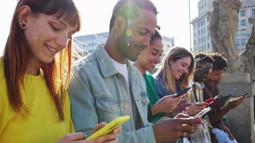 Diverse Group of Young Adults Using Mobile Phones