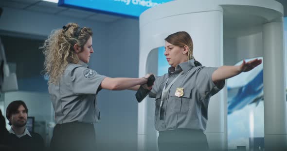 Female TSA Officer Demonstrating Process of Scanning with Metal ...