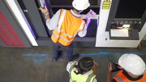 Blue collar workers are working at factory.