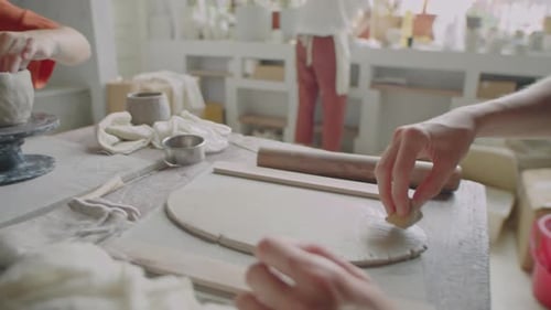 Young Women Working with Clay in Pottery Workshop