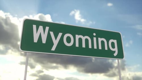Welcome to Wyoming. Wyoming road sign on a blue sky. Travel, business, tourism and transport concept