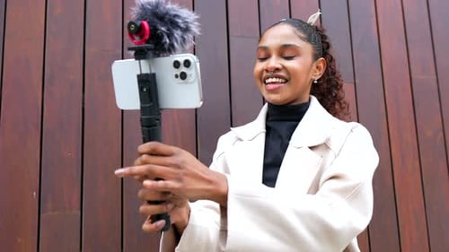 Young Woman Vlogging with Phone in Urban Setting