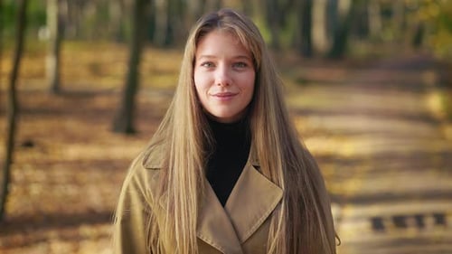 Happy Elegant Woman Wearing Fashionable Clothes Walking in Park