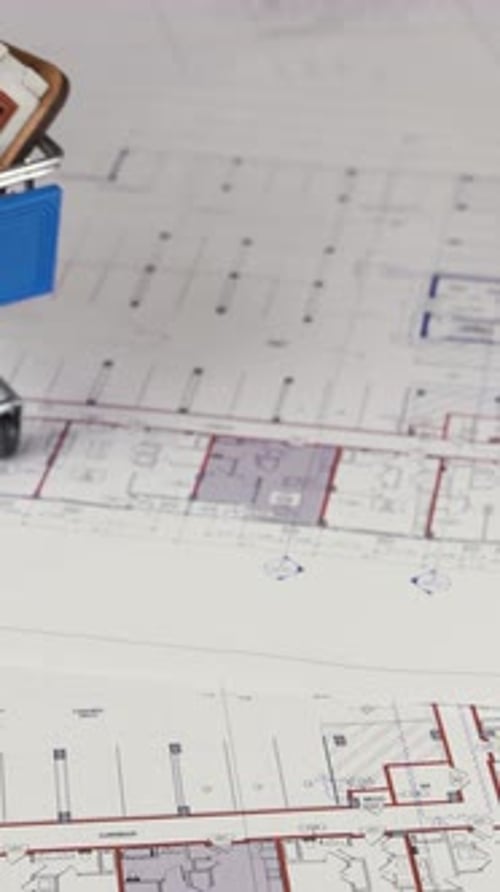 Miniature Shopping Cart with Model Home on Blueprint