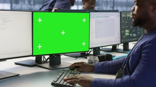 Engineer Using Green Screen Computer Working in Server Farm