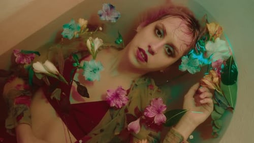 Top Down View of Pretty Girl in Bathwater with Flowers