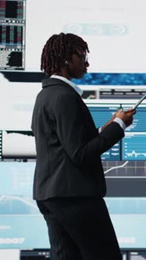Vertical Video Woman Using Tablet to Compare Company KPIs Data