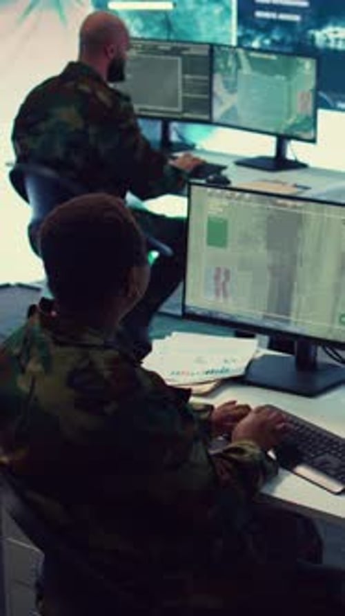 People in Camouflage Working at Computers
