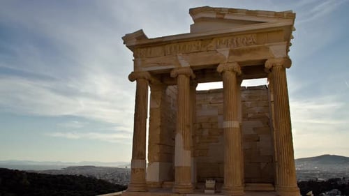 Time Lapse of the sun appearing behind the ancient temple of Athena Nike in the Acropolis in Athens,