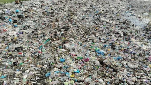 large landfill aerial view. Garbage mountain can with birds and animals. Environmental pollution.