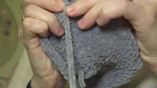 Close-up crocheting with natural wool for the cold winter. Craftsmanship concept and homemade hobbie