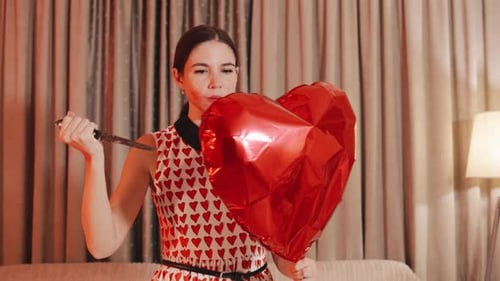 Woman Pops Heart Balloon with Knife
