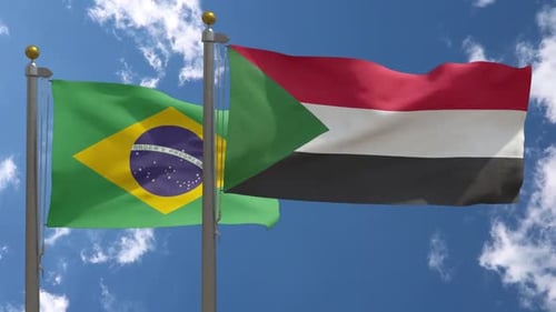 Realistic Brazil and Sudan Flags Waving Against Blue Sky