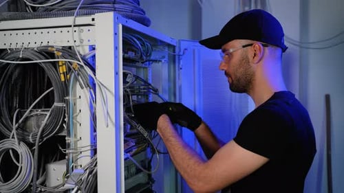 Technician Maintaining Servers in Data Center