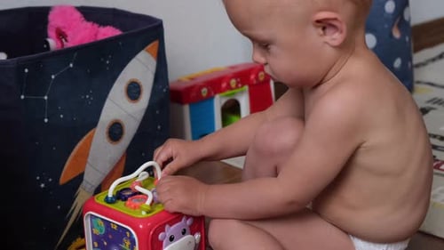 Adorable Child Playing with a Geometric Cube Toy