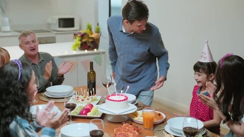 Family and Friends Celebrating Girl's Birthday