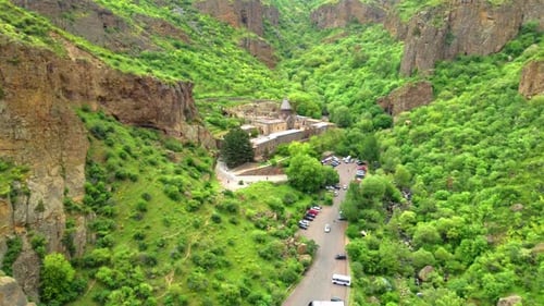 Geghard is medieval monastery in Armenia, carved into nearby mountain.