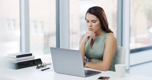 4k video footage of an attractive young businesswoman looking stressed while working in her office
