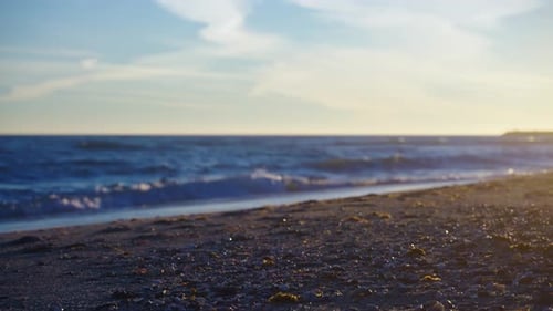 Empty beach with selective focus from the sand into the ocean