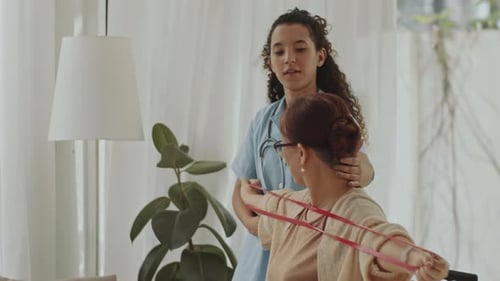 Medical Professional Helping Patient With Arm Exercises